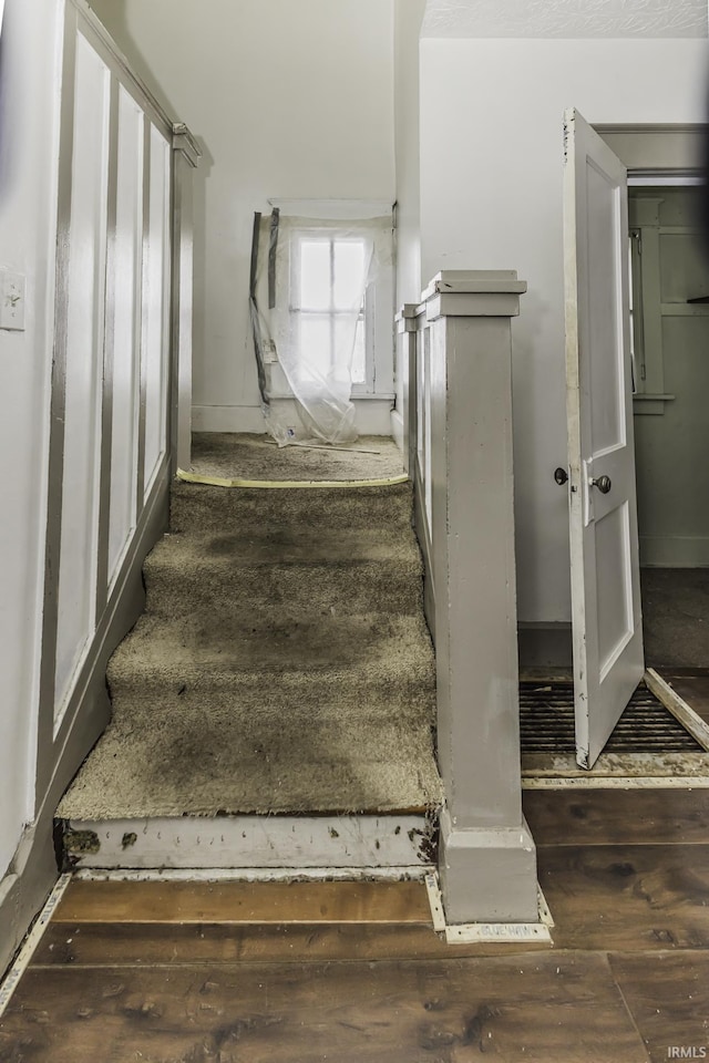 stairs featuring hardwood / wood-style floors