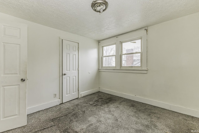 unfurnished bedroom featuring carpet floors and a textured ceiling