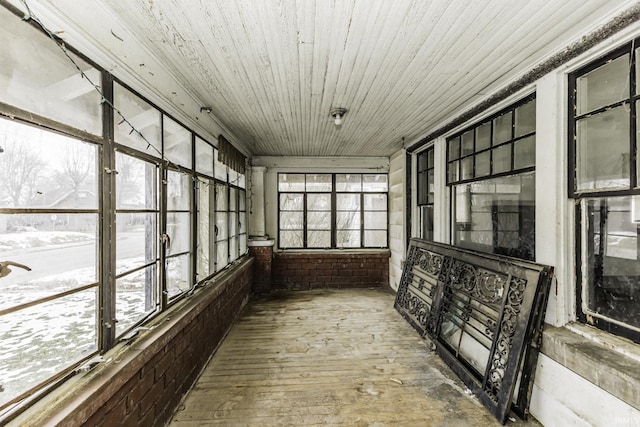 unfurnished sunroom with wood ceiling