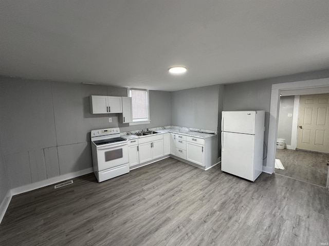 kitchen featuring white appliances, sink, light hardwood / wood-style flooring, and white cabinets