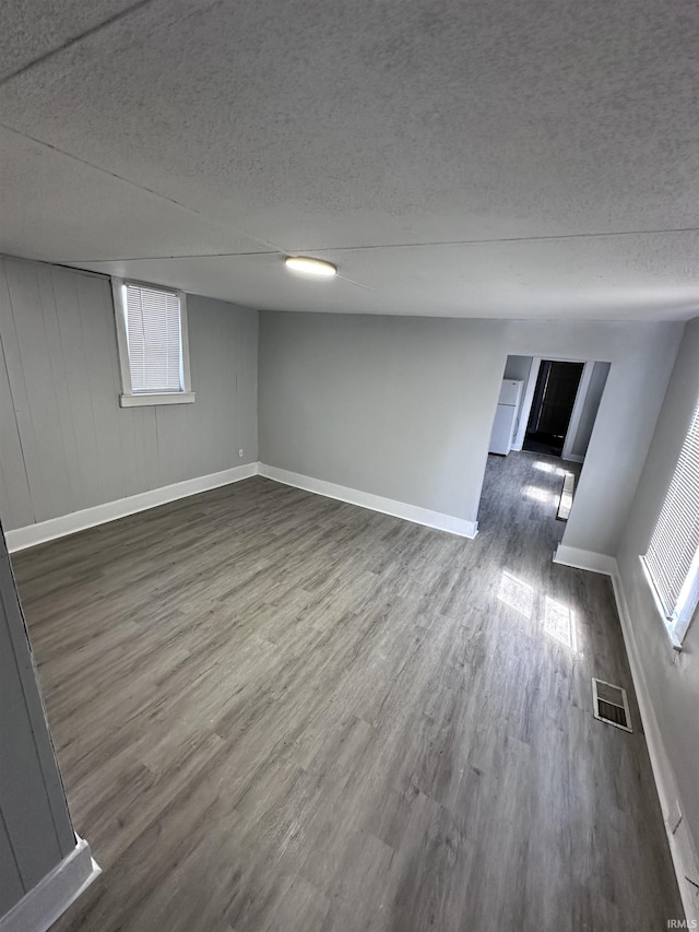 interior space featuring dark hardwood / wood-style floors and a textured ceiling