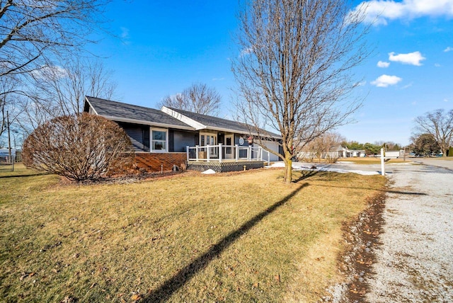 ranch-style house with a porch and a front yard