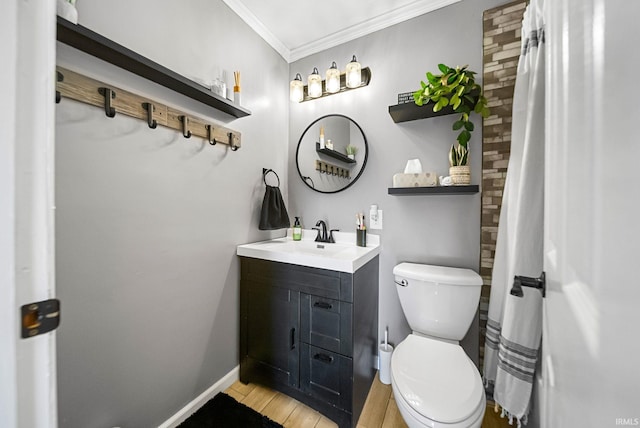 bathroom featuring ornamental molding, toilet, hardwood / wood-style floors, and vanity