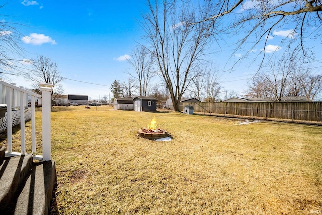 view of yard with a storage unit and a fire pit