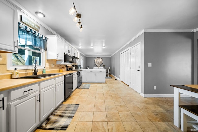 kitchen with hanging light fixtures, white cabinetry, sink, and black appliances