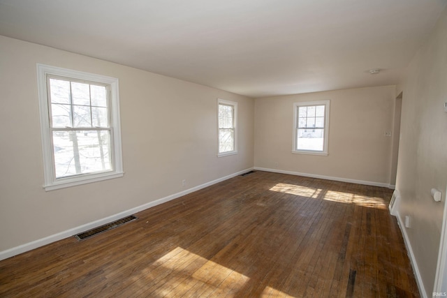 spare room with dark wood-type flooring