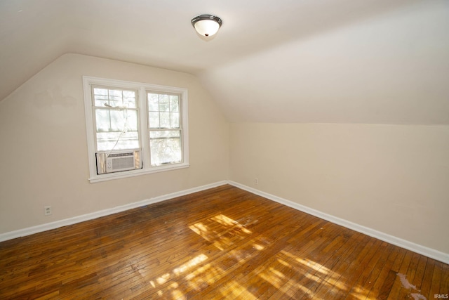 additional living space with lofted ceiling and dark wood-type flooring