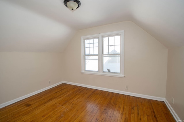 bonus room with lofted ceiling and wood-type flooring