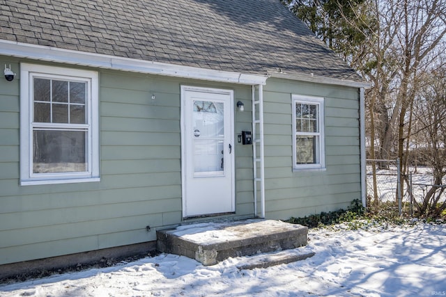 view of snow covered property entrance