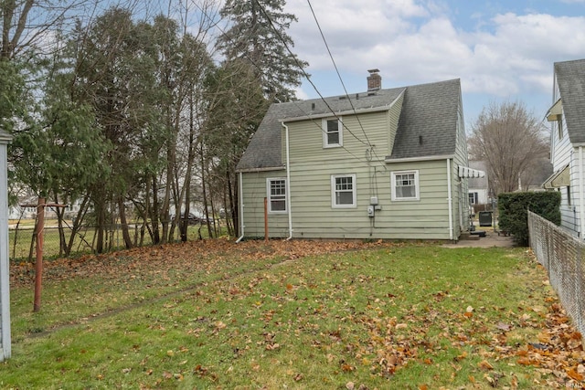 back of property featuring a lawn