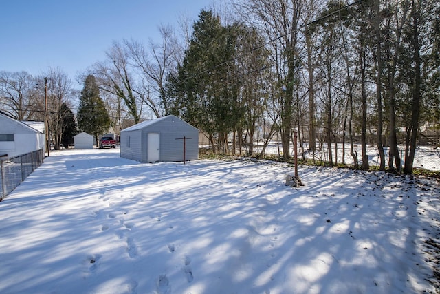 snowy yard with a storage unit