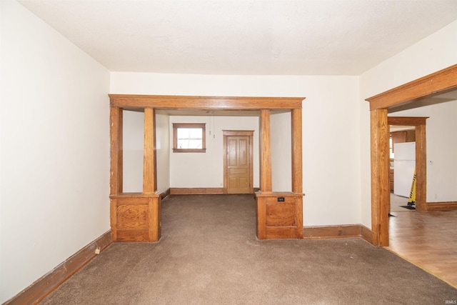 empty room featuring dark colored carpet