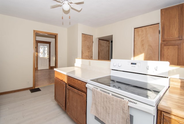 kitchen featuring ceiling fan, white range with electric cooktop, and light hardwood / wood-style floors