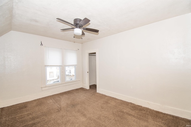 carpeted spare room featuring ceiling fan