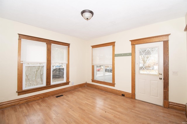 empty room with light hardwood / wood-style flooring