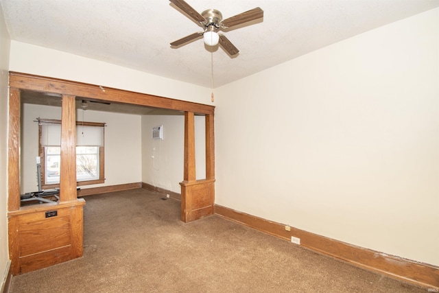 unfurnished room featuring a textured ceiling, an AC wall unit, ceiling fan, and carpet