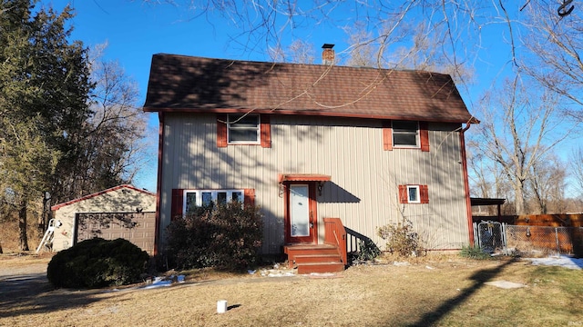 view of front of house featuring a garage and an outdoor structure