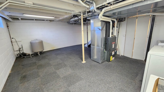 basement with washer / clothes dryer and heating unit