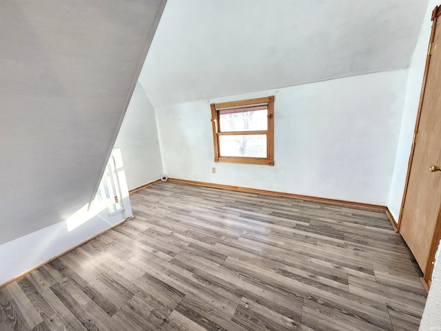 bonus room with vaulted ceiling and hardwood / wood-style floors