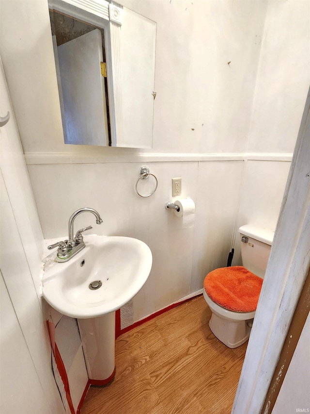 bathroom featuring hardwood / wood-style flooring and toilet