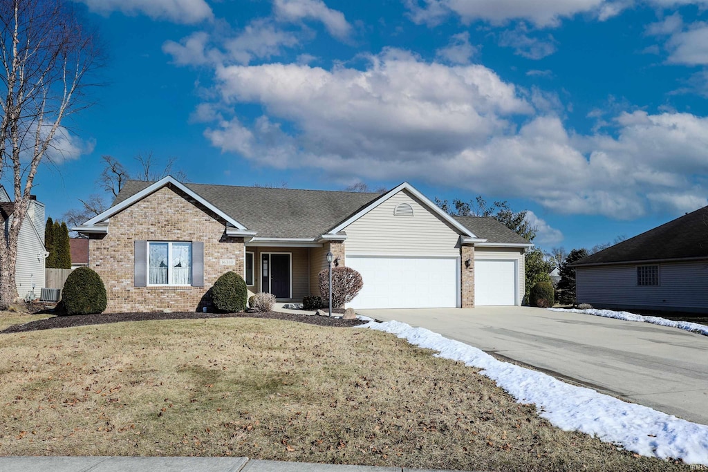 view of front of home with a garage and a front yard