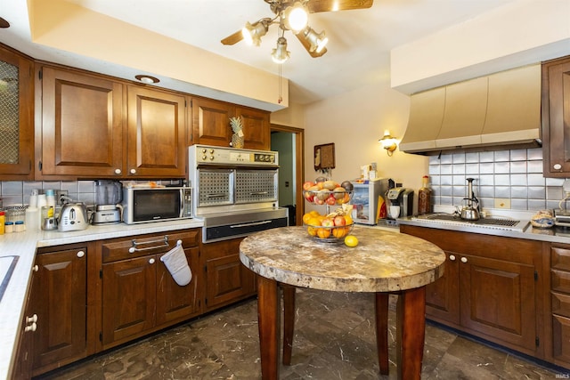 kitchen featuring tasteful backsplash, appliances with stainless steel finishes, and ceiling fan