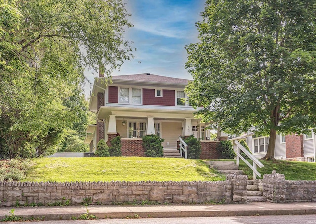 view of front of property featuring a porch and a front yard