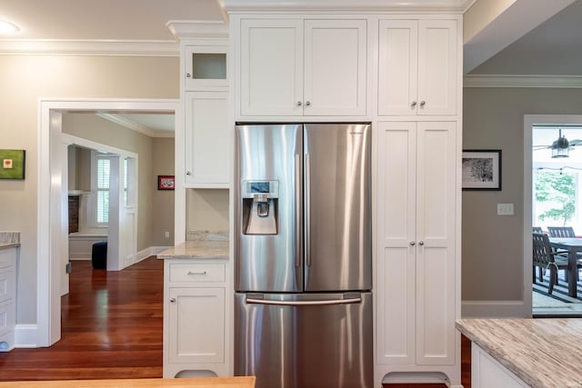 kitchen featuring ornamental molding, light stone countertops, stainless steel fridge with ice dispenser, and white cabinets