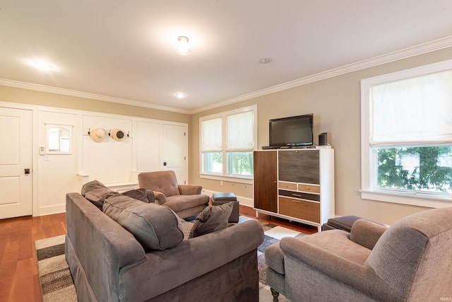 living room with crown molding, a healthy amount of sunlight, and wood-type flooring