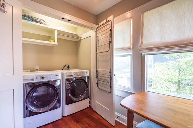 clothes washing area with washing machine and dryer and dark hardwood / wood-style flooring