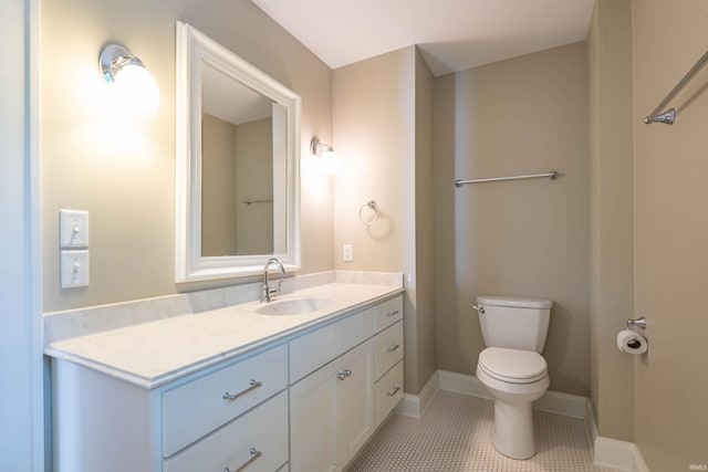 bathroom featuring tile patterned flooring, vanity, and toilet