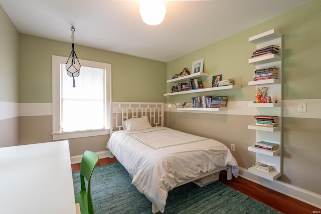 bedroom with dark hardwood / wood-style floors