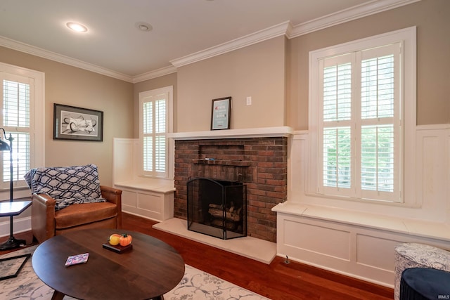 living room featuring crown molding, a fireplace, and dark wood-type flooring