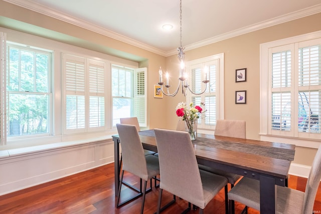 dining area featuring ornamental molding, a chandelier, and dark hardwood / wood-style flooring