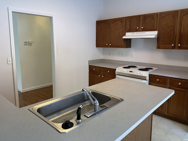 kitchen featuring sink and white electric range oven