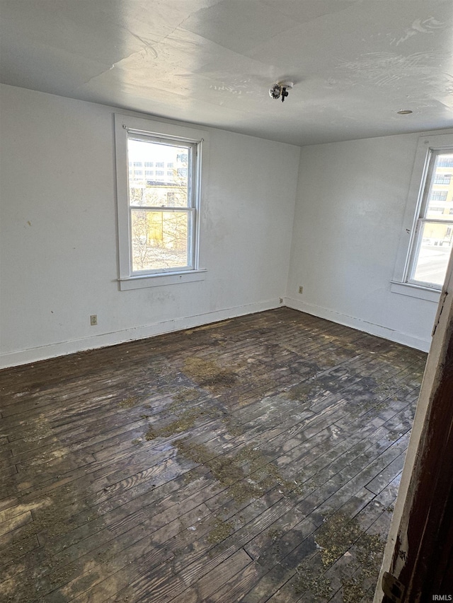 unfurnished room with dark hardwood / wood-style floors