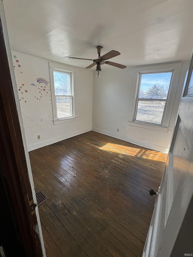 spare room with ceiling fan and dark hardwood / wood-style flooring