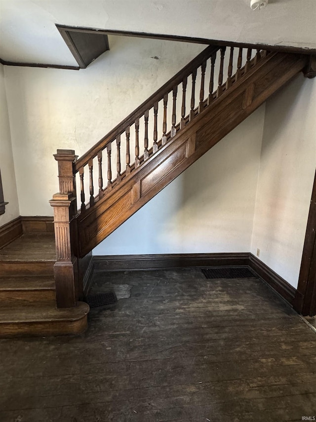 stairway with hardwood / wood-style flooring