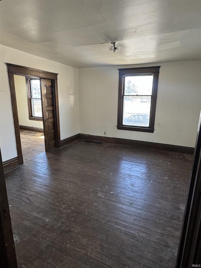 empty room with dark hardwood / wood-style floors