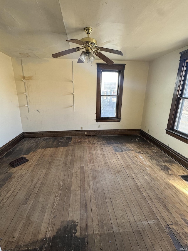 unfurnished room with ceiling fan and dark hardwood / wood-style flooring