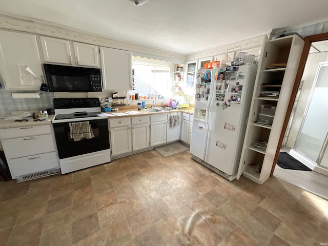 kitchen with white cabinetry, electric range oven, white refrigerator with ice dispenser, and sink