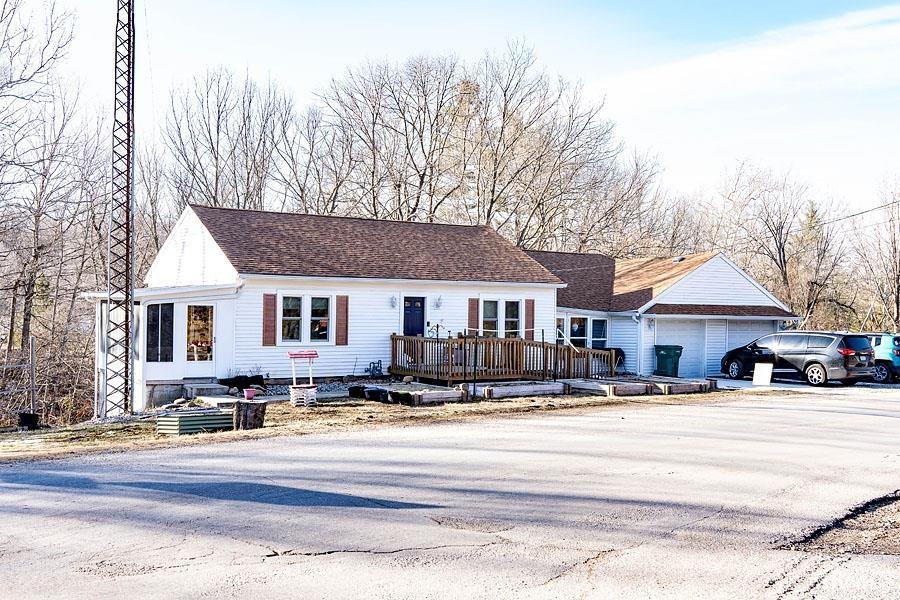 view of front of property featuring a garage and a deck