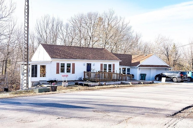 view of front of property featuring a garage and a deck