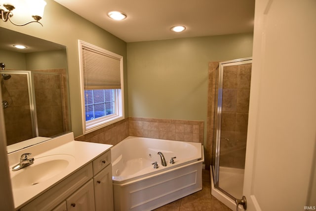 bathroom with tile patterned flooring, vanity, and shower with separate bathtub