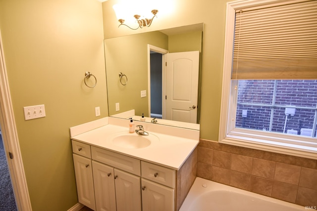 bathroom with vanity and a tub