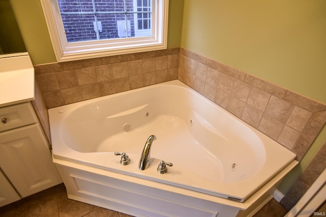 bathroom featuring tile patterned floors, vanity, and a bath