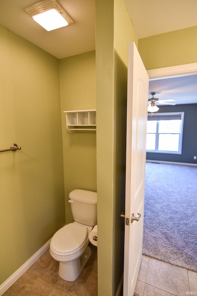 bathroom with tile patterned flooring, ceiling fan, and toilet