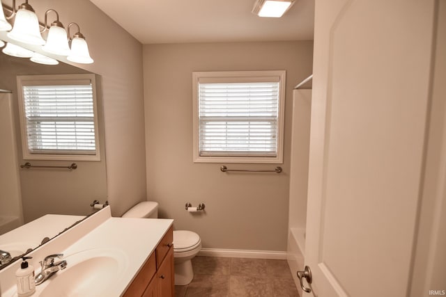 bathroom featuring vanity, a notable chandelier, and toilet