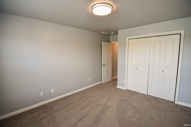 unfurnished bedroom with a closet and carpet