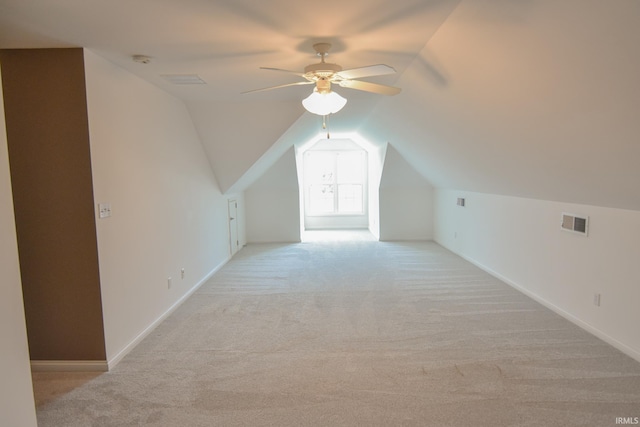 additional living space featuring ceiling fan, light colored carpet, and vaulted ceiling